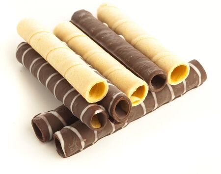 chocolate wafer tubes on a white backgroundの写真素材