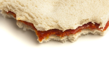 closeup of a bited sandwich on a white backgroundの写真素材