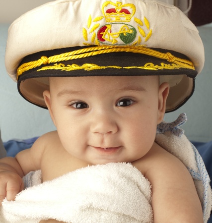little 4 month baby happy with sailor capの写真素材