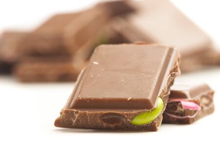 chocolate bar with dolorful candies on white