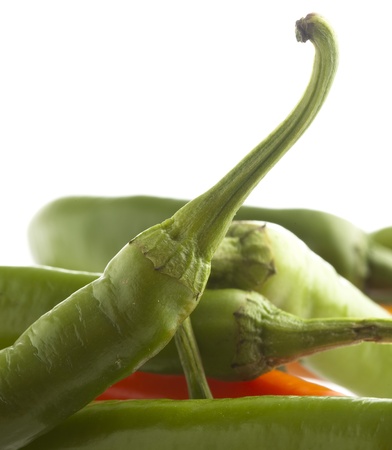 red and green chilli peppers on a white backgroundの写真素材