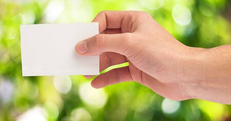 hand holding a card on a white backgroundの写真素材