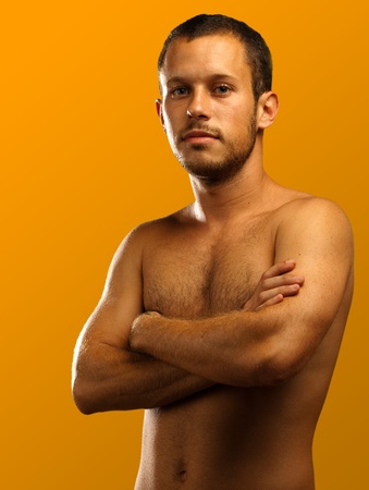 man shirtless on a orange backgroundの写真素材