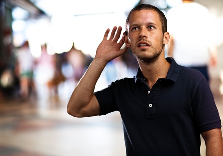 man hearing sounds at shopping center