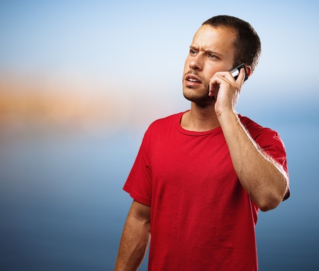 young businessman calling on mobile phone in the beachの写真素材