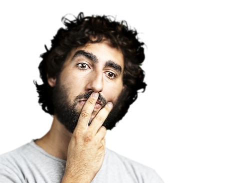 portrait of young man thinking against a white background