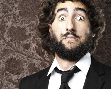 portrait of afraid young man against a retro wallの写真素材