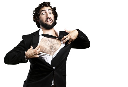 portrait of young business man tearing his suit over white