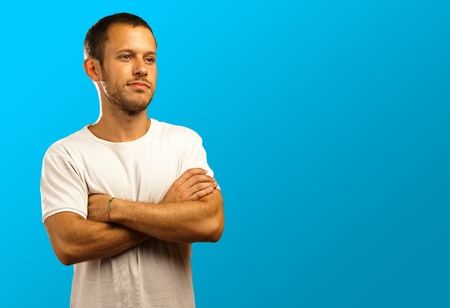 man with a white t-shirt on a blue backgroundの写真素材