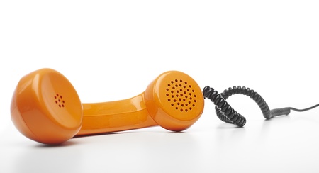 vintage orange telephone handset over white background