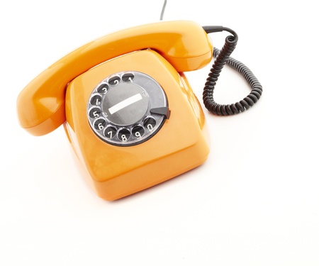 orange vintage telephone isolated on whiteの写真素材
