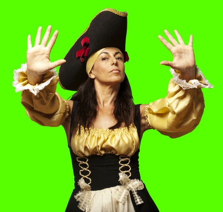 portrait of pirate woman gesturing stop against a removable chroma key backgroundの写真素材