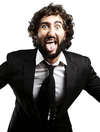 portrait of young man joking and showing the tongue over white backgroundの写真素材