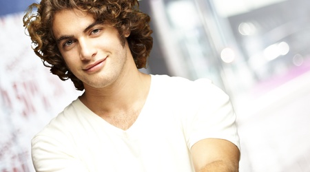portrait of young man smiling against a city background