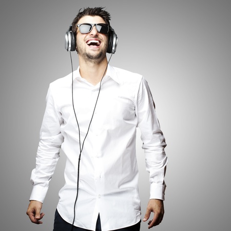 portrait of a handsome young man listening to music with headphonesの写真素材