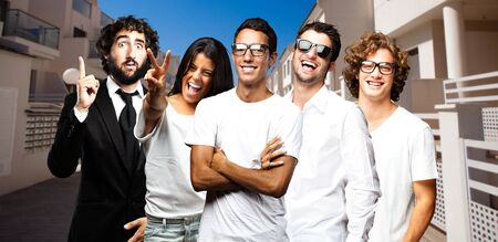 young businesss team smiling near a apartmentの写真素材