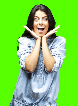 portrait of surprised young woman against a removable chroma key backgroundの写真素材