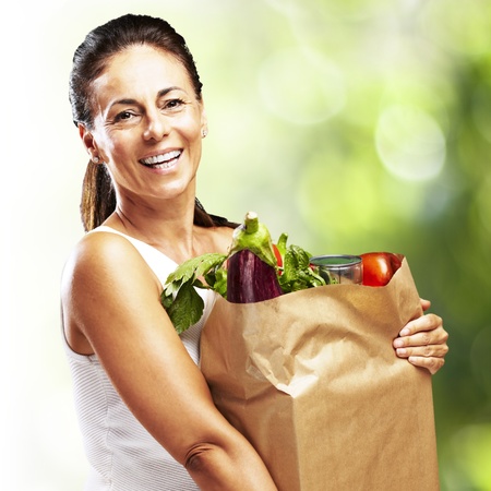 woman with purchase against a nature backgroundの写真素材