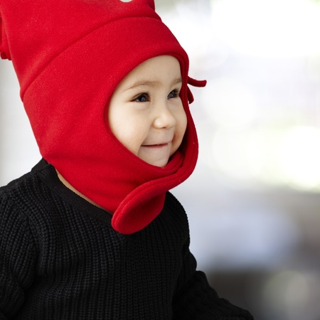 young happy boy wearing red winter accessories, indoorの写真素材
