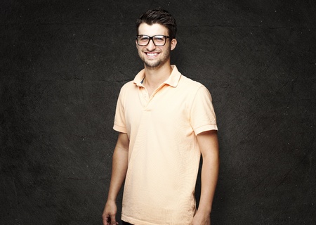 portrait of a handsome happy man against a grunge wallの写真素材