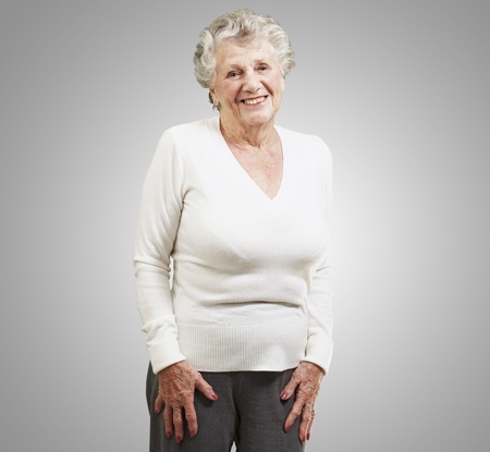 pretty senior woman smiling against a grey backgroundの写真素材