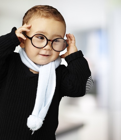 sweet boy wearing round glasses, indoorの写真素材