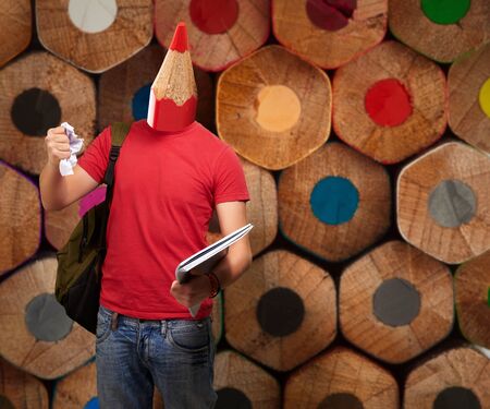 portrait of young student with crayon head crumpling a sheet