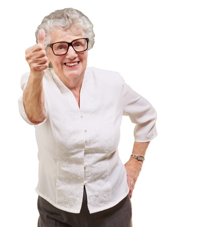 portrait of adorable senior woman doing good gesture over whiteの写真素材