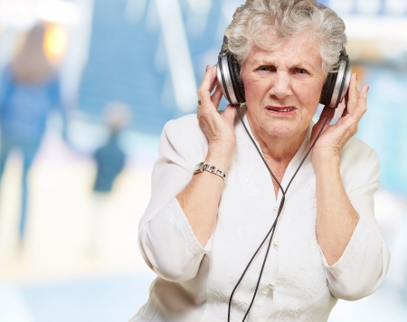 portrait of senior woman listening to music indoorの写真素材