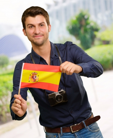 Portrait of a young man holding a flag, outdoorの写真素材