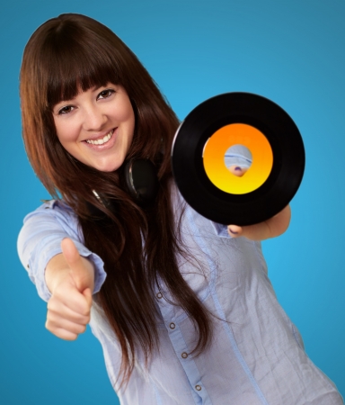 Portrait Of A Female Holding A Disc On A Blue Backgroundの写真素材