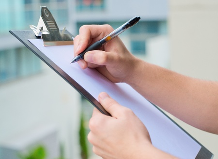 Businessman Holding A Clipboard And Writing, Out Doorの写真素材