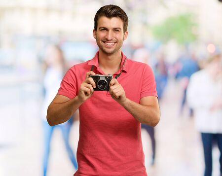 Portrait Of A Man Holding Camera, Outdoor