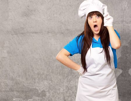 portrait of female chef shocked, indoorの写真素材