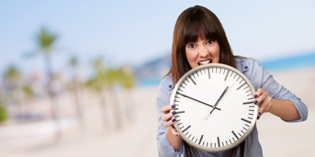 A Young Girl Holding A Clock And Angry, Indoor
