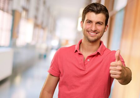 young man smiling with thumbs up, indoor young man smiling with thumbs up, indoor