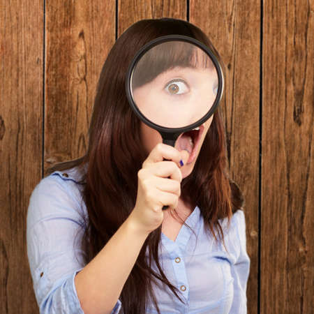 Woman Holding Magnifying Glass, Indoor