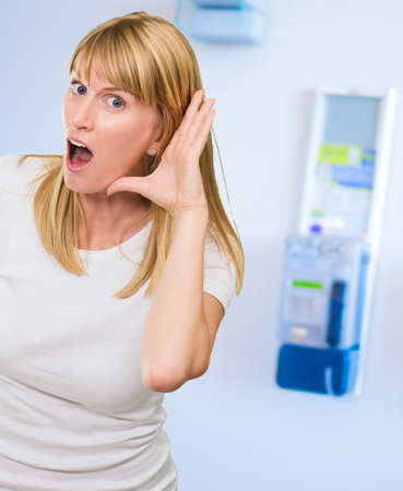 Woman Listening Gossip against a background with a phone box