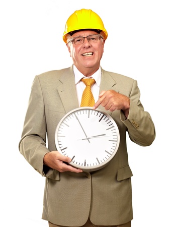 Portrait Of A Senior Man Holding A Wall Watch On White Backgroundの写真素材
