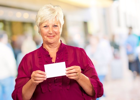 Senior Woman Holding A Card, Outdoorの写真素材