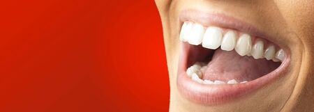 Close Up Of Smiling Teeth against a red background
