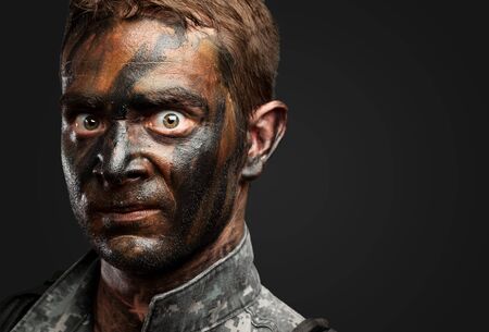 Closeup of a soldier against a black backgroundの写真素材