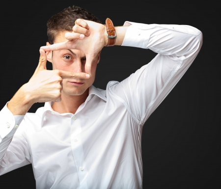 Portrait Of Man Gesturing against a black backgroundの写真素材