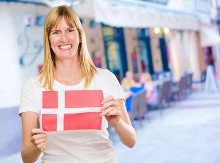 woman holding a denmark flag, outdoorの写真素材