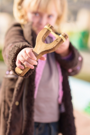 Blonde Girl Aiming With A Sling Shot, Outdoors
の写真素材