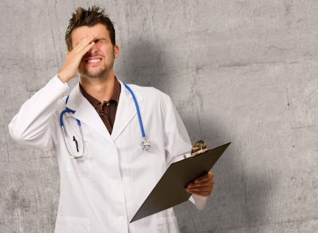 Portrait Of Young Frustrated Doctor, Indoorsの写真素材