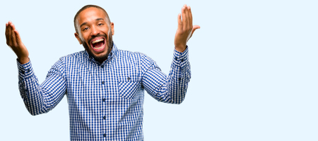 African american man with beard confident and happy with a big natural smile welcome gesture isolated over blue backgroundの写真素材