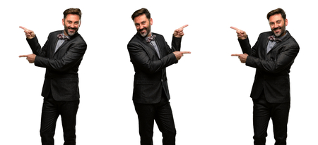 Middle age man, with beard and bow tie pointing away side with fingerの写真素材