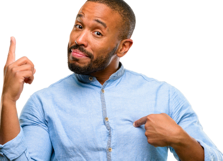 African american man with beard happy and surprised cheering expressing wow gesture pointing up isolated over white backgroundの写真素材