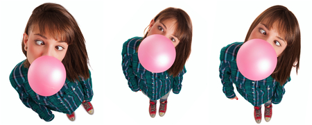 Beautiful young woman on high angle wearing shirt gesturing, smiling and doing silly face while chewing gumの写真素材